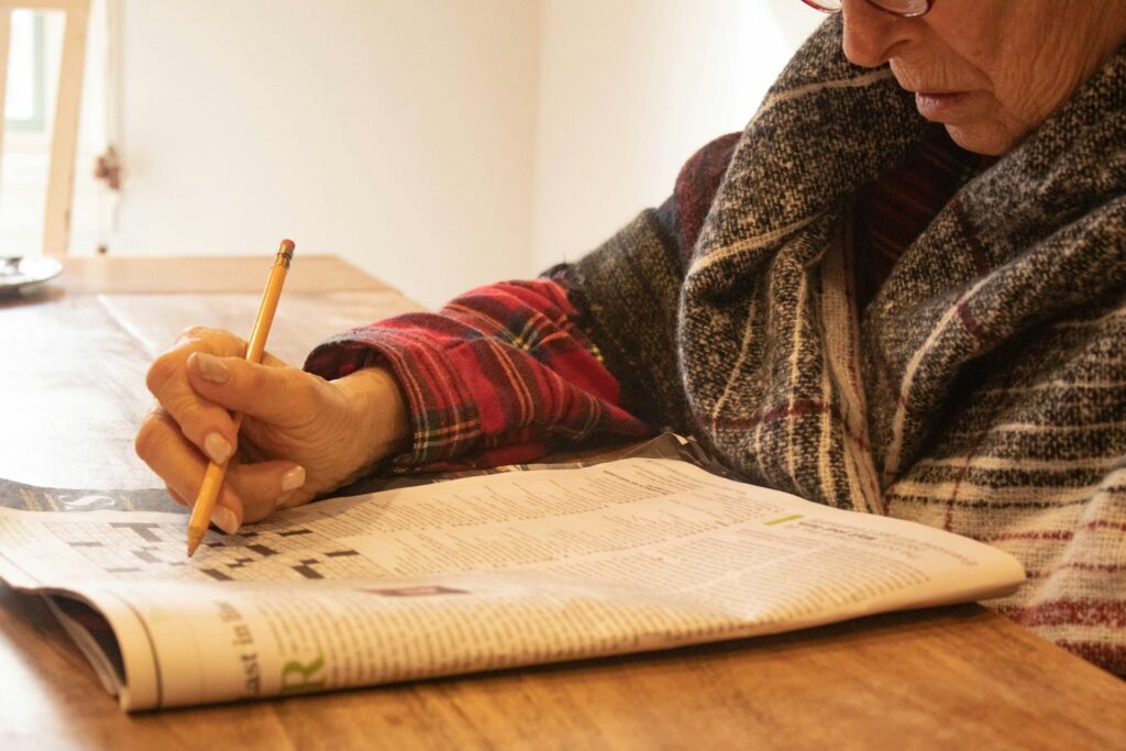 lady doing crossword in newspaper