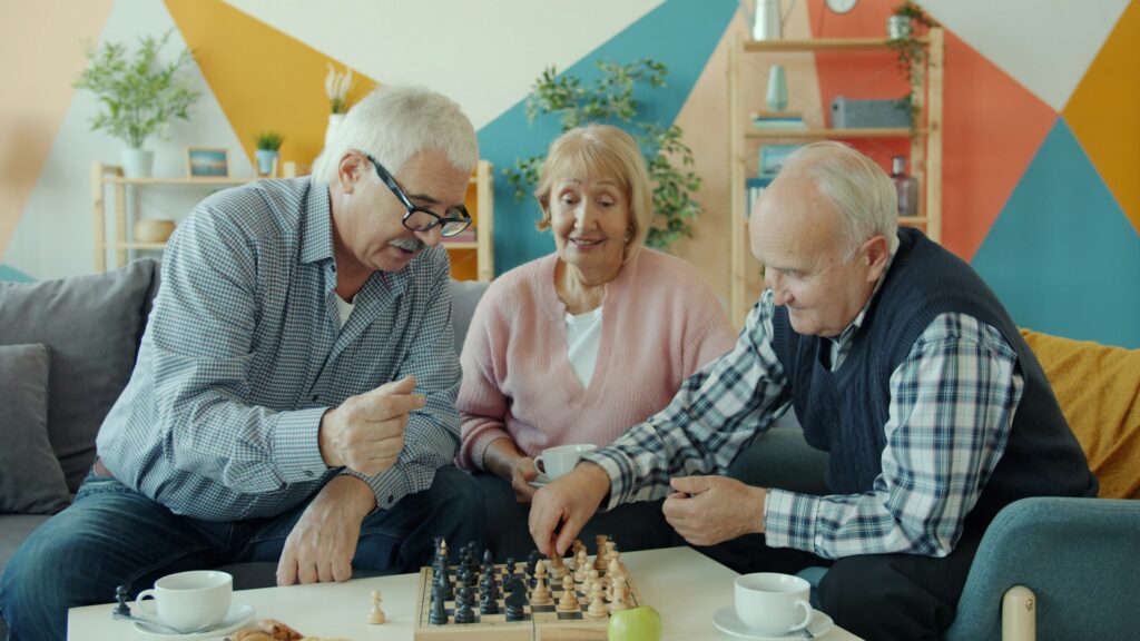 elderly people playing chess
