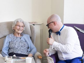 friary care resident being sung to