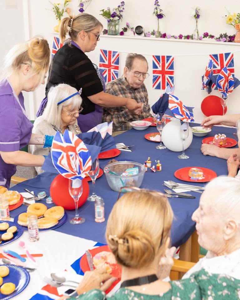 decorating cakes and donuts as part of d day remembrance at friary. care
